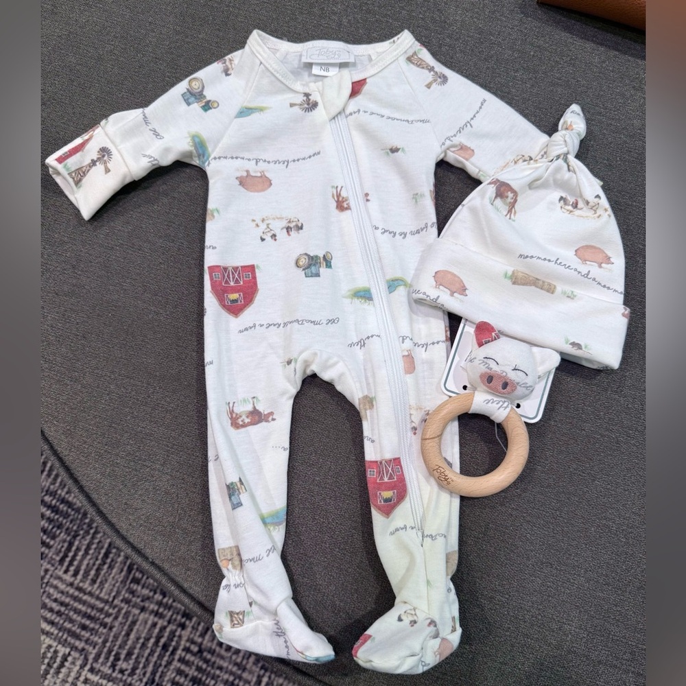 Newborn footie new without tags comes with a cute beanie and toy !
